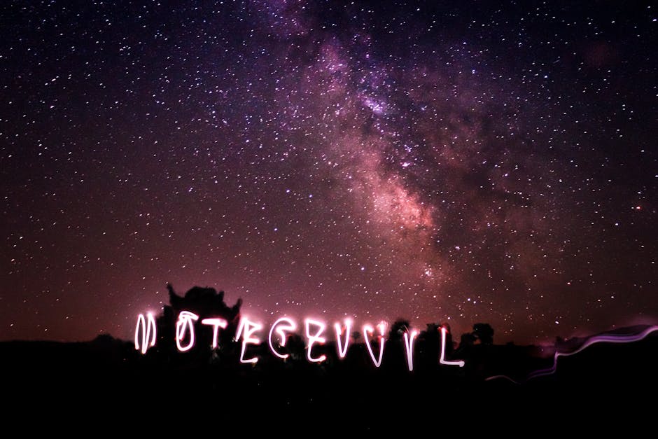 Illuminated light writing under a stunning starry night sky and bright Milky Way.
