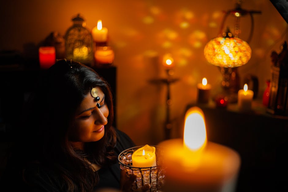 A woman embraces a tranquil moment surrounded by candlelight and warm glow in a cozy setting.