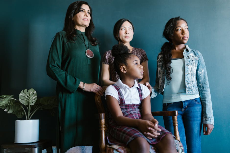 A diverse group of women and a girl, representing unity and strength, indoors.