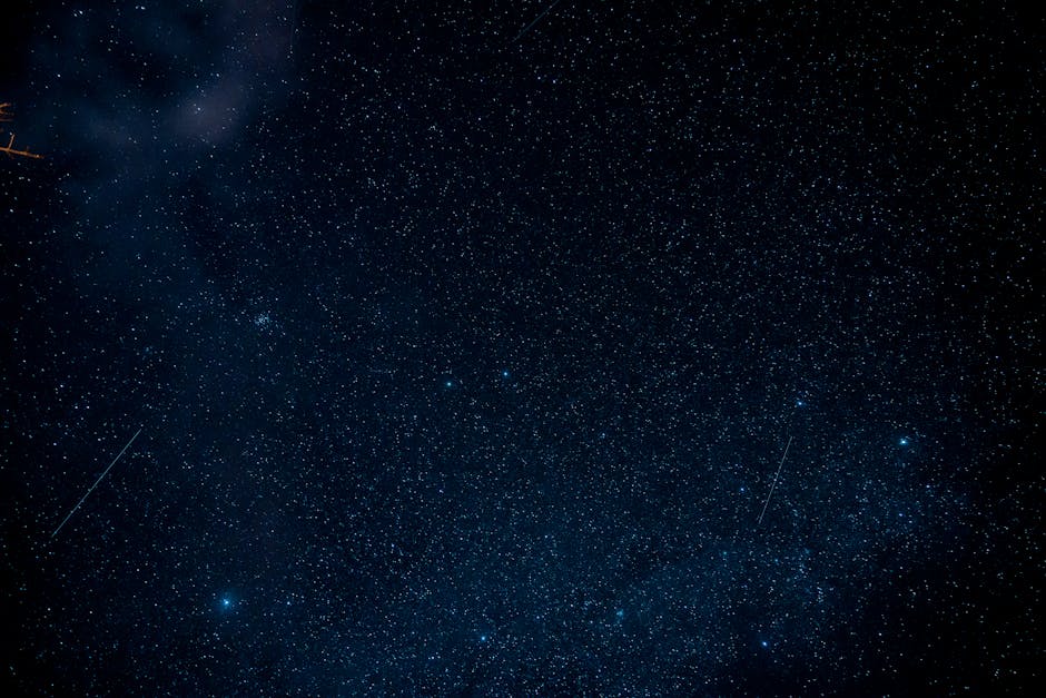 A mesmerizing view of a starry night sky with numerous stars and shooting stars, ideal for astronomy enthusiasts.