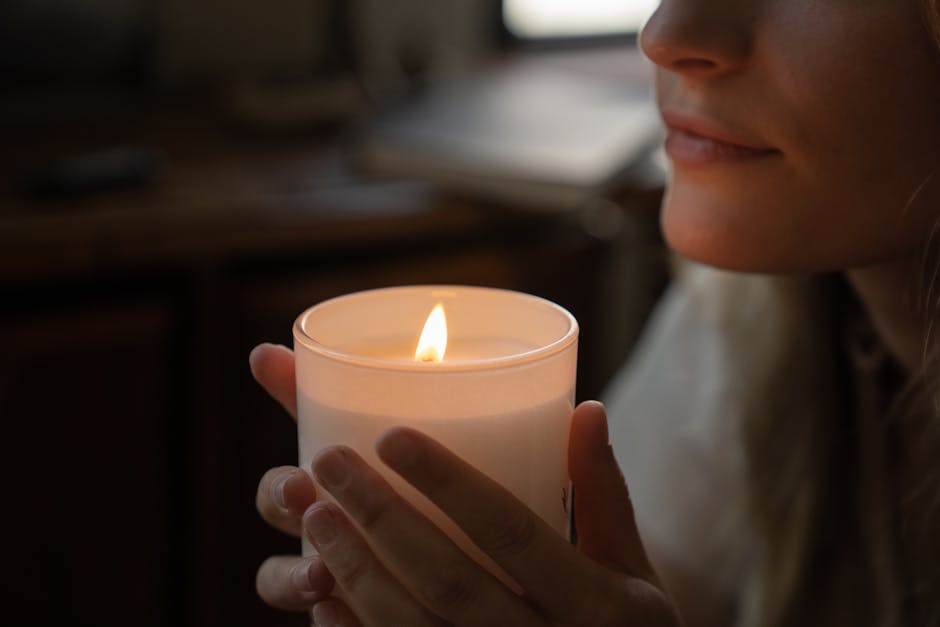 A tranquil scene of a woman holding a lit candle, capturing gentle candlelight and serene mood.