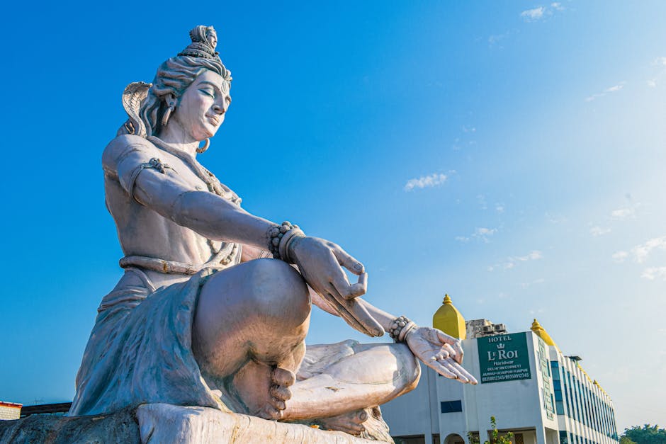Magnificent low-angle view of Lord Shiva statue against a blue sky in Haridwar, India.