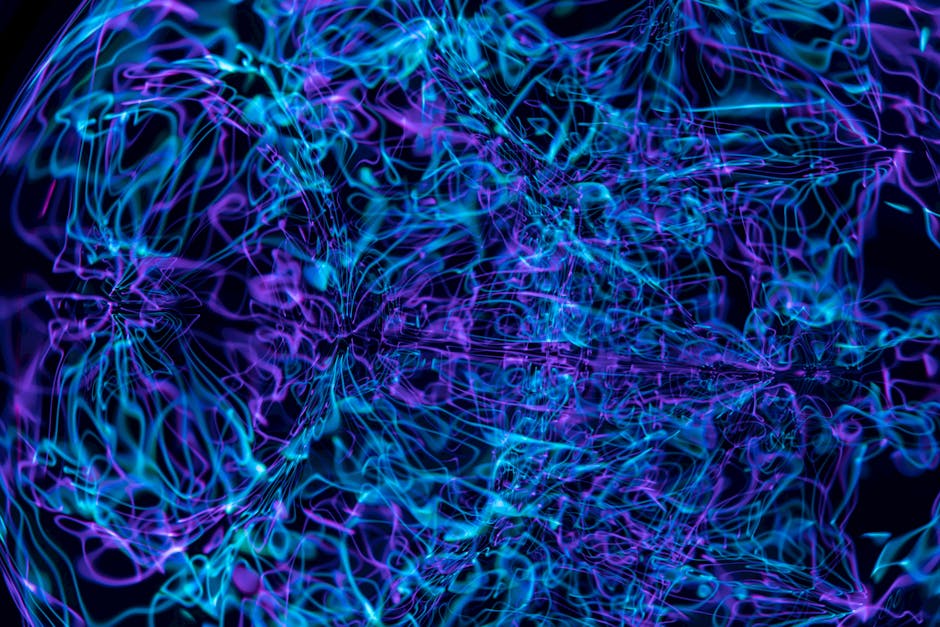 Dynamic abstract image with swirling neon lines creating vibrant, colorful patterns.