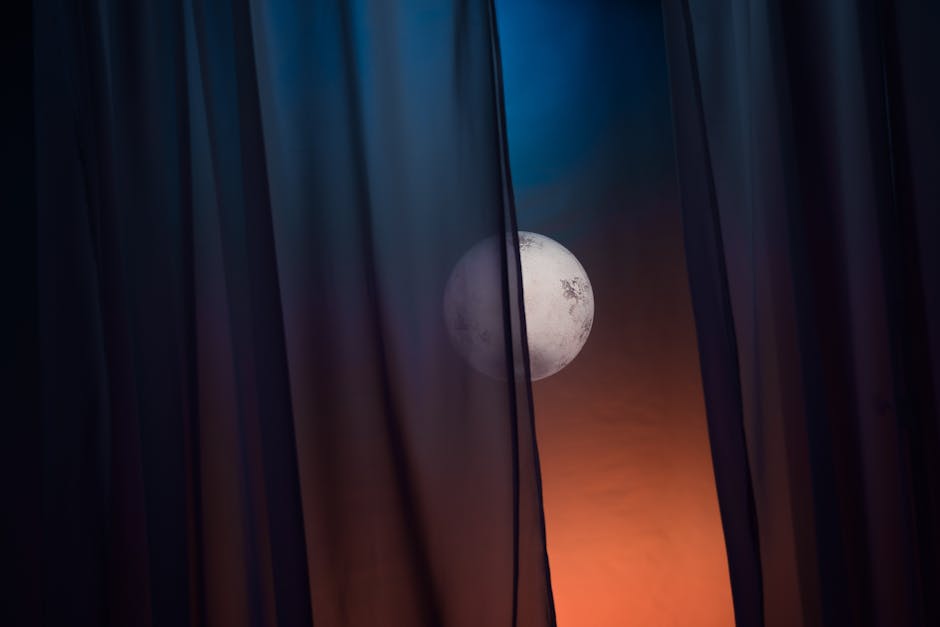 A full moon gently glows through parted dark curtains, creating a mystical night sky ambiance.