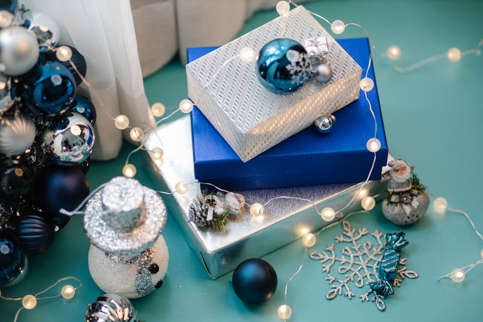 Bright and colorful Christmas gift boxes surrounded by festive decorations like a snowman and baubles.