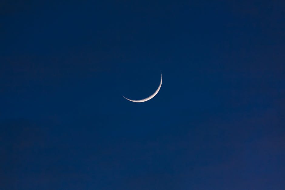 A serene crescent moon set against a deep twilight sky, offering a sense of tranquility and wonder.