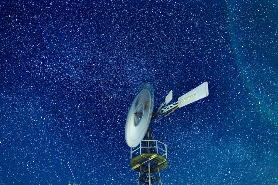 Wind turbine against a vibrant starlit night sky, showcasing the beauty of renewable energy.