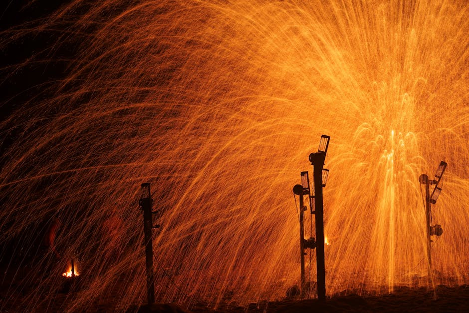Dazzling orange sparks and light show in a night setting captured beautifully.