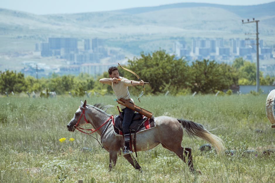 An archer riding a horse takes aim in the open fields of Konya, Turkey.