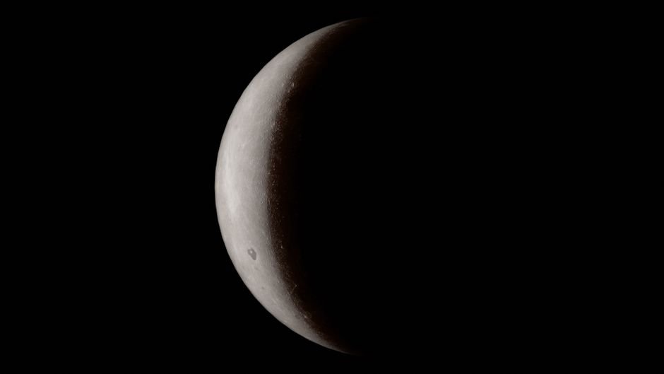 A detailed close-up of a crescent moon against a deep black space background.