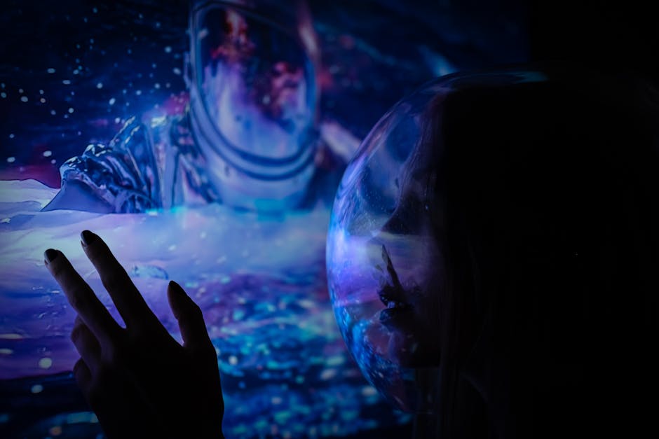A hand touches a cosmic image of an astronaut with ethereal reflections, evoking imagination.