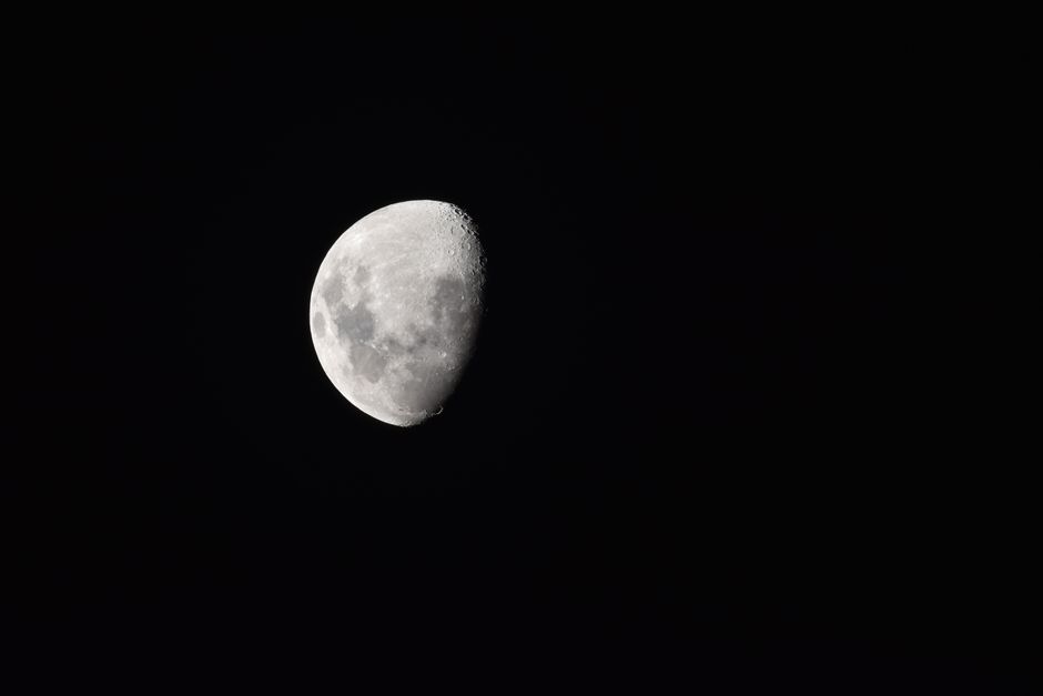 A mesmerizing view of a waning gibbous moon against the clear night sky.