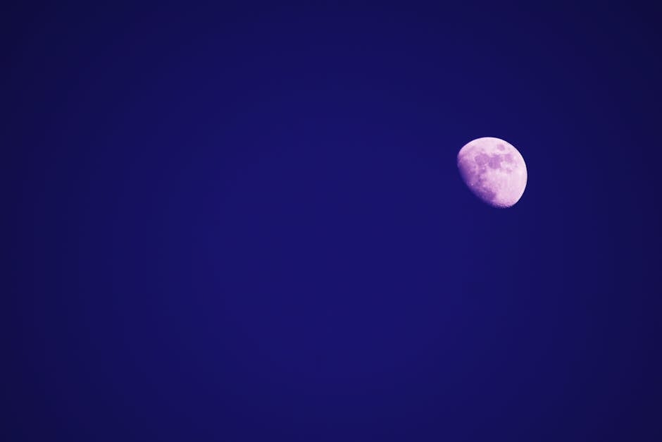 Captivating image of the moon shining brightly in a clear deep blue night sky.