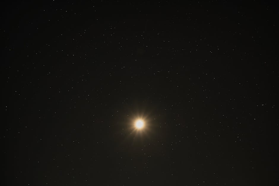 A stunning view of the bright moon surrounded by a starry sky over Poprad, Slovakia.