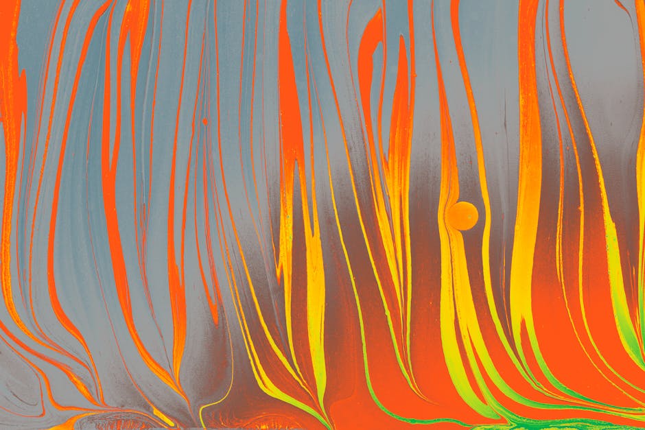 Dynamic abstract marbling artwork with vibrant orange and yellow swirls on a muted background.