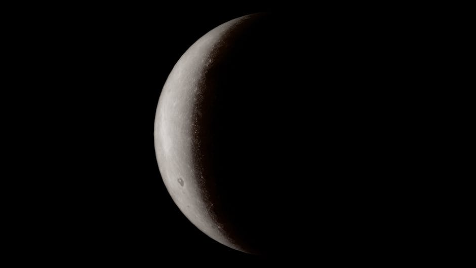 A detailed close-up of a crescent moon against a deep black space background.