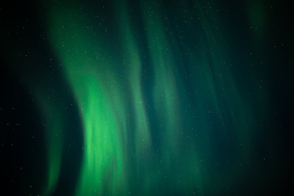 A breathtaking view of the aurora borealis illuminating the night sky with shimmering green lights.