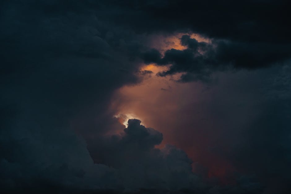 A captivating view of a dramatic stormy sky with glowing clouds breaking through darkness.