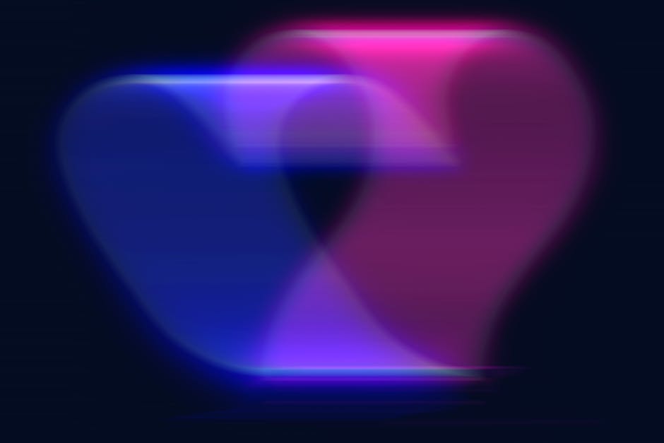 A colorful abstract heart shape in vibrant neon colors with a blurred motion effect.
