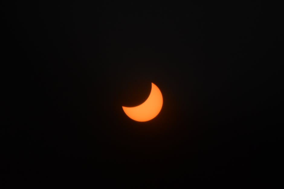 A captivating view of a crescent solar eclipse against a dark sky.
