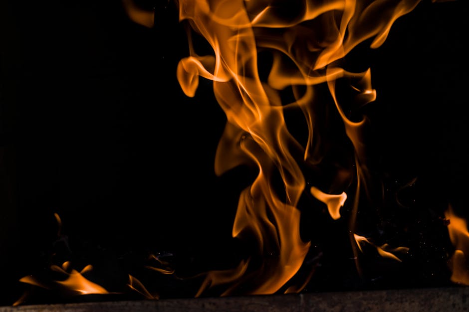 Captivating image of vivid flames against a dark backdrop, creating a dramatic contrast.