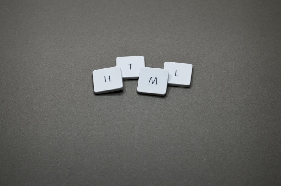 Minimalist image of HTML keycaps against a gray background, perfect for digital and web design themes.