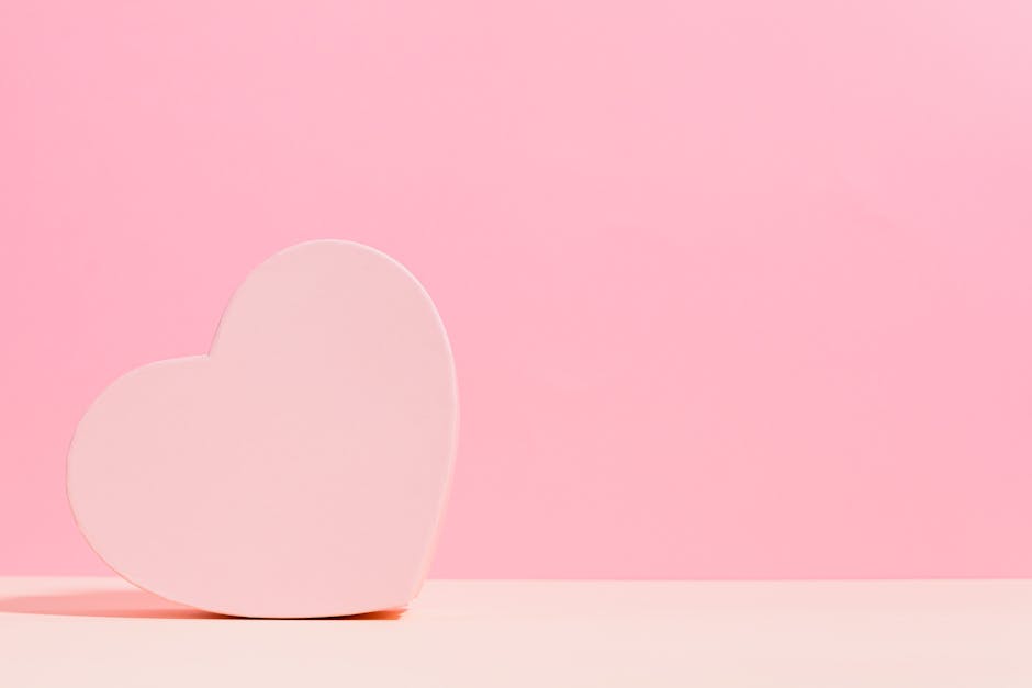 Simple heart-shaped decoration with a pastel pink background, perfect for romantic themes.