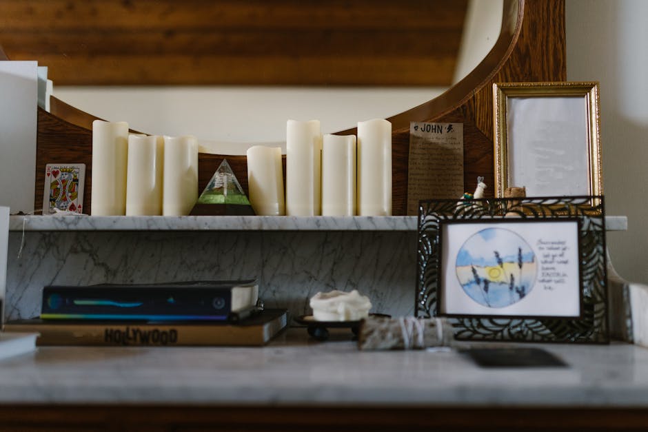 An indoor altar with candles, tarot card, crystal pyramid, and artistic decor.