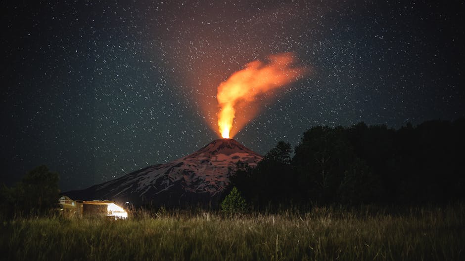 A dramatic night view of Villarrica Volcano erupting under a starry sky in Araucanía, Chile.