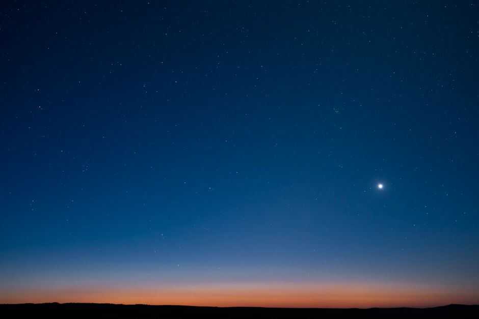 Starry night sky at dusk with visible horizon in East Wenatchee, Washington.