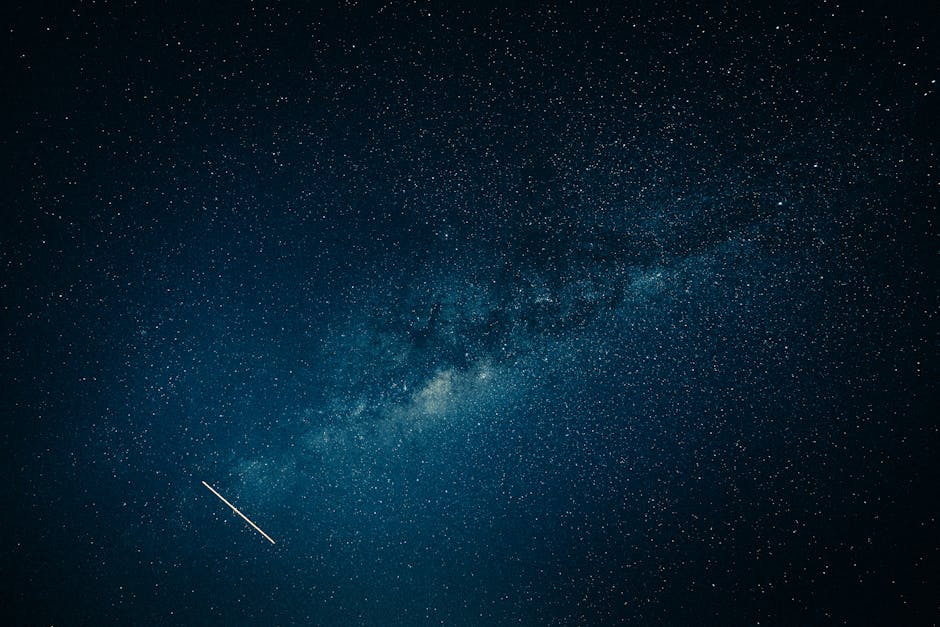 Captivating view of the Milky Way galaxy and a shooting star across a clear night sky.