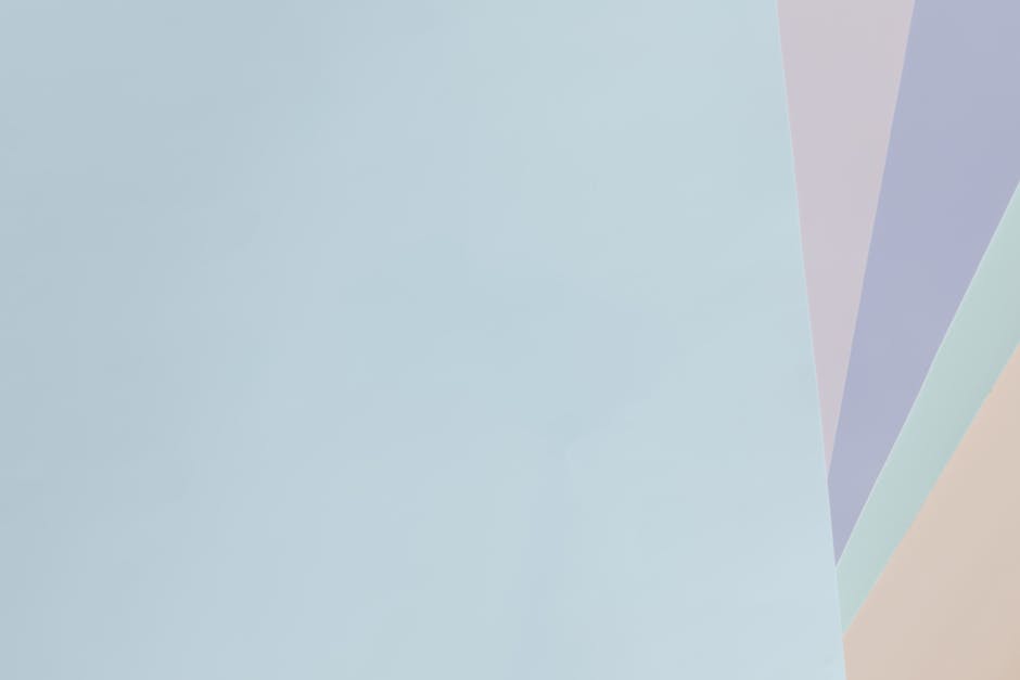 Minimalist pastel abstract background with light blue, purple, and beige shades.