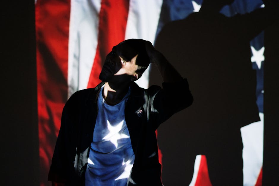 Faceless silhouette of a man with an American flag projection.