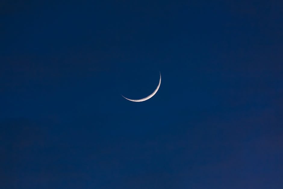 A serene crescent moon set against a deep twilight sky, offering a sense of tranquility and wonder.
