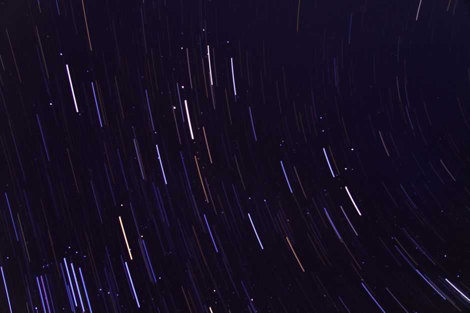 Stunning long exposure image capturing vivid star trails against a deep night sky, showcasing celestial movement.