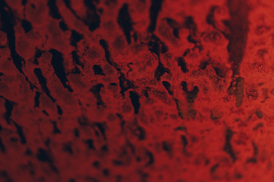 Close-up of a textured red and black abstract pattern. Ideal for backgrounds or artistic designs.
