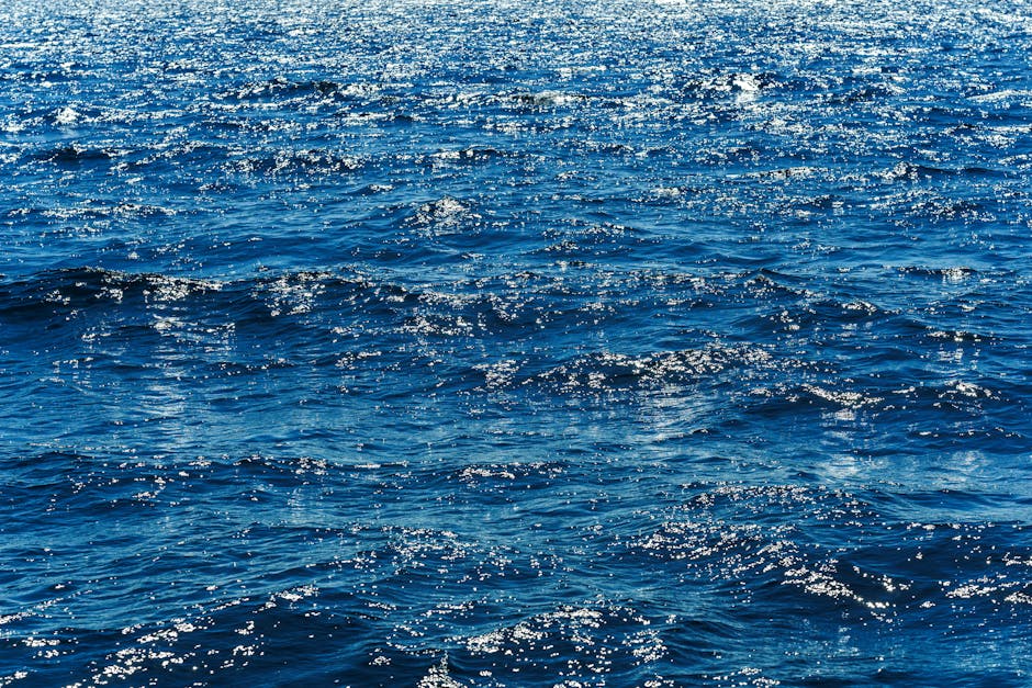 Vibrant blue ocean waves sparkling under the bright sun, showcasing the vastness of the sea.