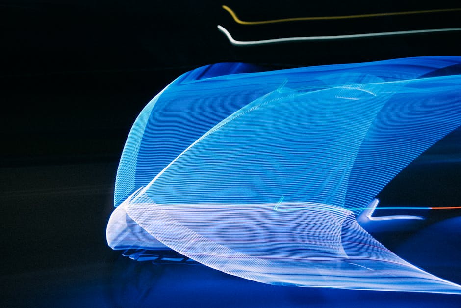 Abstract motion blur of blue light streaks on a black background creating a futuristic visual effect.