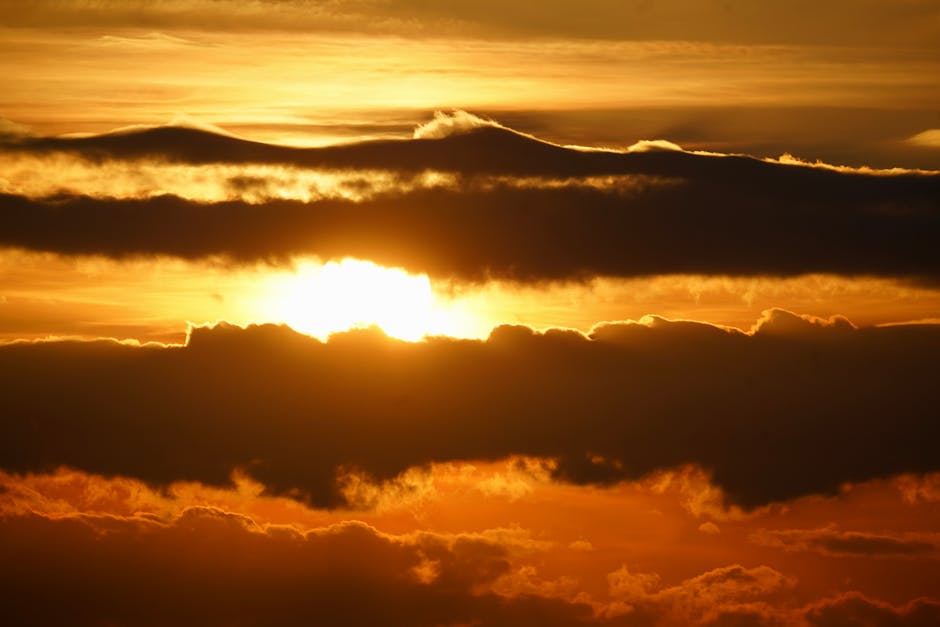 A breathtaking sunset with golden clouds and a vibrant sky, creating a dramatic scene.