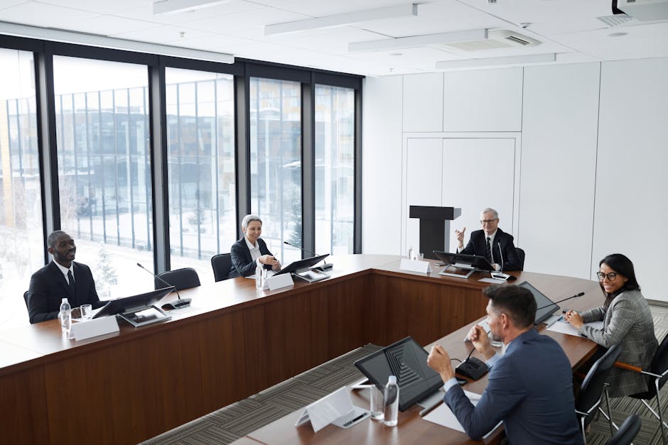 Professionals engaged in a collaborative discussion at a modern office conference room.