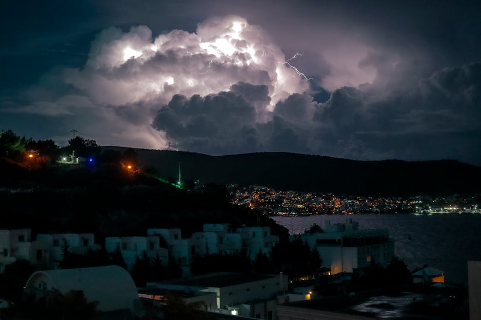 Captivating long exposure of lightning illuminating clouds over a city. Perfect for weather and urban concepts.