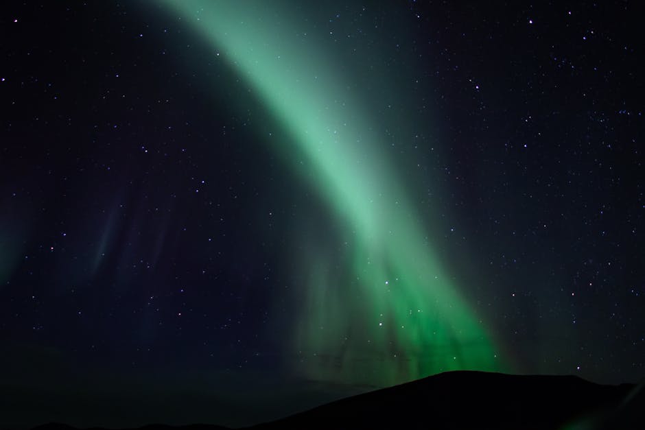 Breathtaking view of the aurora borealis illuminating the night sky filled with stars.