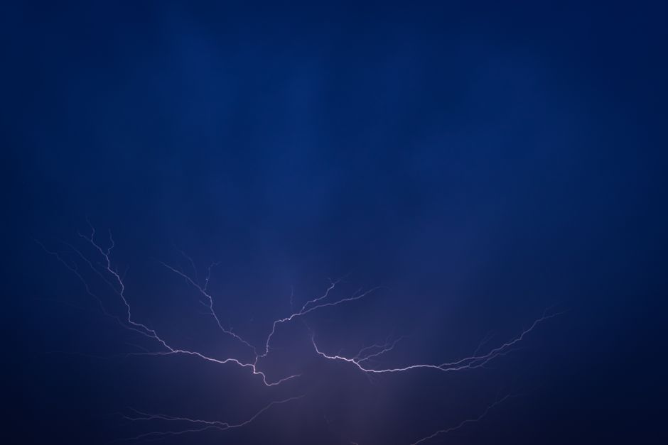 Stunning photograph of lightning in a dark night sky, capturing nature's power.