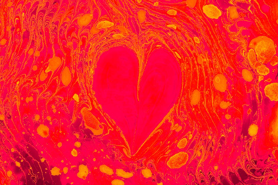 A colorful abstract image featuring a heart shape with swirling patterns in vivid red and yellow hues.