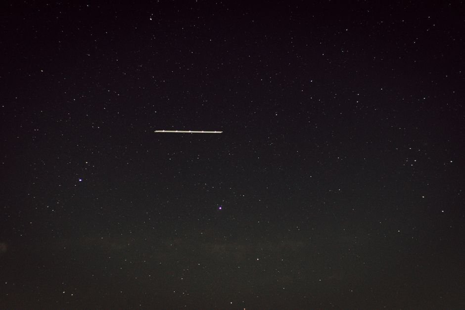Captivating star-filled night sky with a mysterious line of light, captured in Germany.