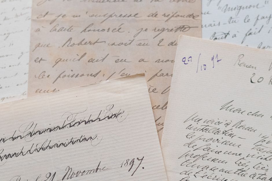 A collection of vintage handwritten letters in French, showcasing elegant cursive calligraphy on aged paper.