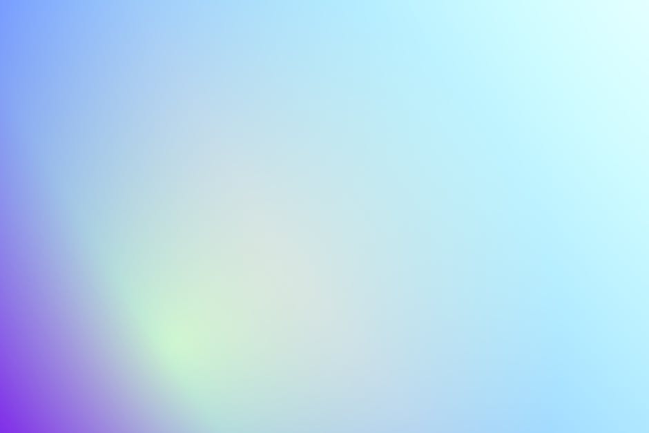 A vibrant abstract gradient background featuring soft hues of purple, blue, and green.