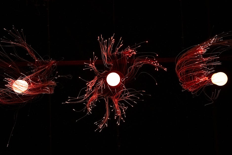 Close-up image of glowing fiber optics lights against a black background.