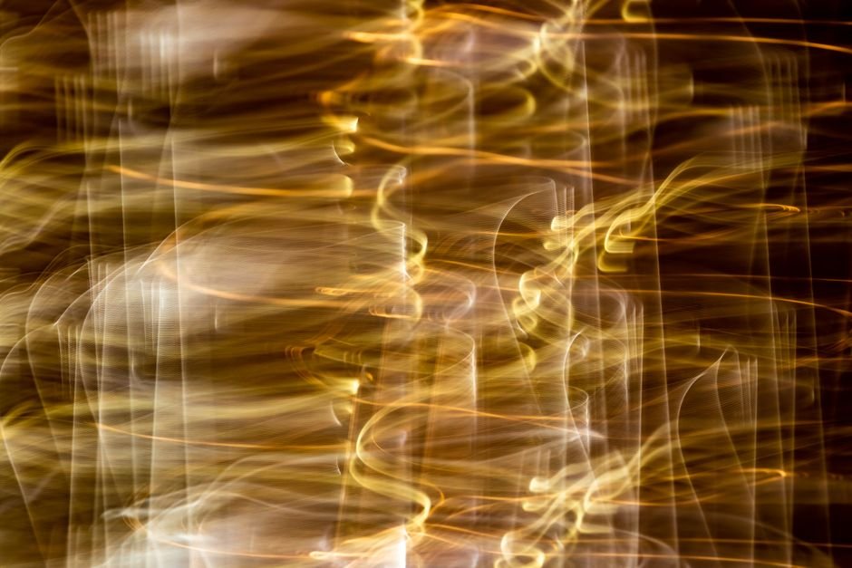 Vibrant abstract image showcasing golden light streaks with long exposure effect.